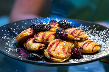 Close-up of a plate with lemon curd cookies and wild berries.