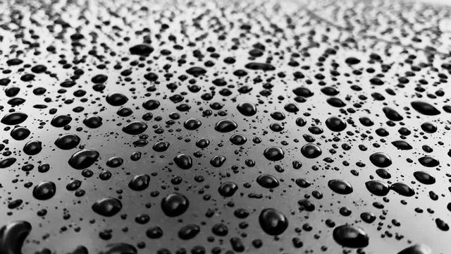 Rain drops on a glossy car surface, cloudy weather, reflection, texture, Effect anti-rain