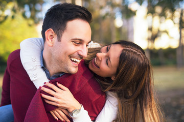 Boyfriend carrying his girlfriend on his back.