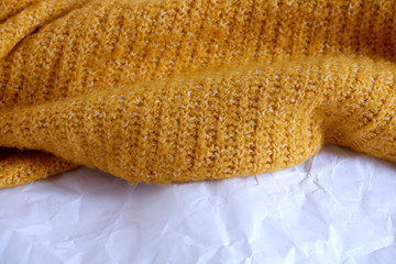 Texture of yellow woolen fabric and crumpled white paper. Advertising background. Texture