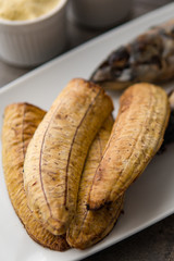 African fried food dish. Grilled chicken with plantain. Nigerian cuisine.