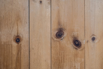 Rustic, natural,  knotty pine boards on a wall in a vertical composition