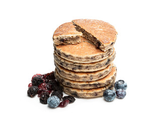 Stack of welsh cakes with dry berries and fresh blueberries isolated on white