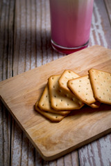 Square of crackers on wooden tray. crispy bread for relaxing time. delicious snack.