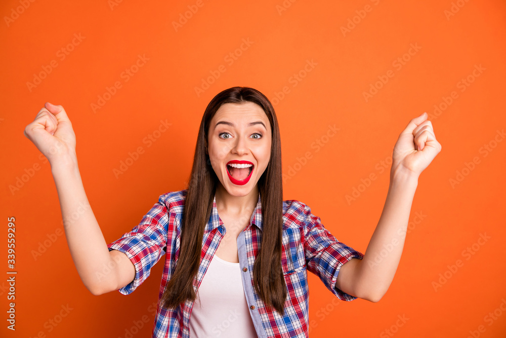 Poster Portrait of positive cheerful girl celebrate lottery win raise fists scream yeah feel ecstatic wear good look clothes isolated over vibrant color background