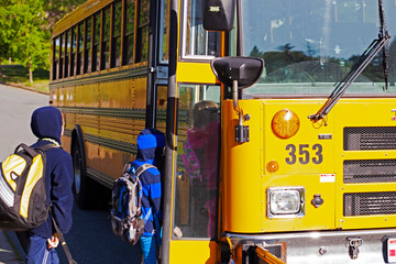 Children climbing on to school bus