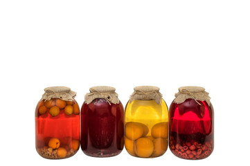 Homemade canned fruit compote in large glass jar. Preserved organic summer fruit drinks. Apricot, apple, raspberry, peach compotes