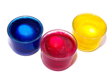 the Process of painting eggs in red, blue, yellow. Preparing for the Easter holiday. space for text.