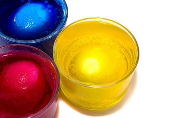 the Process of painting eggs in red. Preparing for the Easter holiday.