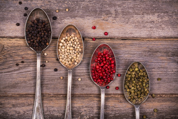 Peppercorns in silver spoons