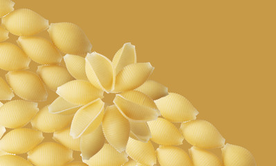 raw italian pasta background. mustard color