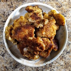 chicken nuggets in bowl on wooden kitchen table