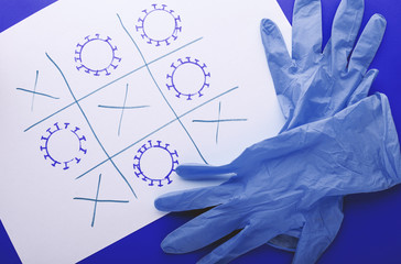 Medical gloves and drawing of a coronavirus