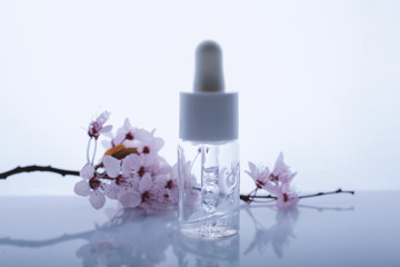 Bottle of hyaluronic acid with pipette on light background