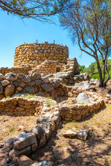 Arzachena, Sardinia, Italy - Archeological ruins of Nuragic complex La Prisgiona - Nuraghe La Prisgiona - with stone main tower and preserved remaining of Neolithic fortress - obrazy, fototapety, plakaty