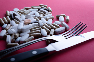 We eat a lot of pills. Fork, knife and pills