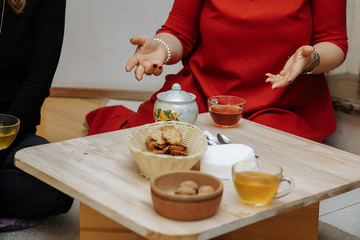 Tea ceremony. Girlfriends drink tea and rides cookies.