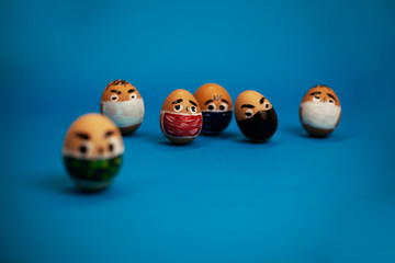 bunch of eggs with eyes and masks on a blue background