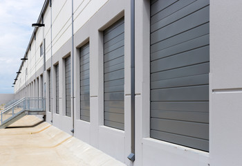 Empty warehouse loading dock white walls gray metal sliding doors