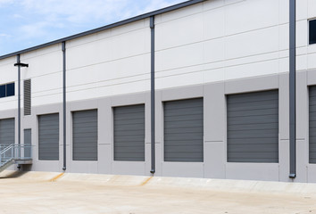 Empty warehouse loading dock white walls gray metal sliding doors