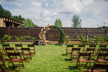 the wedding ceremony is decorated with flower arrangements and candle stands in a country restaurant 