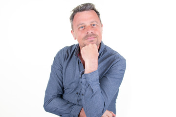 handsome man smiling with hand on chin over white background