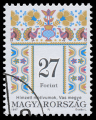 Stamp printed in Hungary shows Folk Art motives