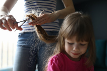 Mom cuts hair at home child during quarantine closed all hairdressers. Domestic lifestyle on covid 19 time concept