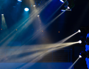 Theater lights spotlights and smoke over the stage, texture background for design.