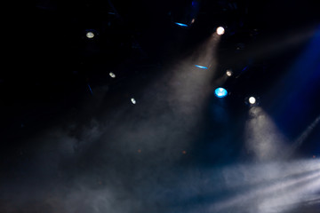Theater lights spotlights and smoke over the stage, texture background for design.