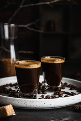 Espresso coffee in two glasses. Dark background. Dark style