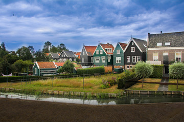 Colorful houses in Marken with a canal past it