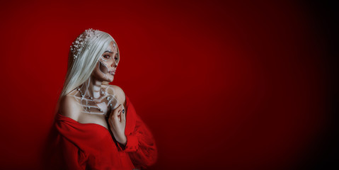 Art portrait young beautiful woman. Creative makeup scary sexy face image sugar skull. Blond wig...
