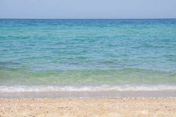 Fototapeta na wymiar The endless surface of the sea and the sandy beach. Halkidiki, Greece.