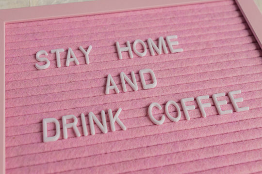 Quote stay home amd drink coffee on pink background.  Work at home during coronavirus pandemia. freelance.