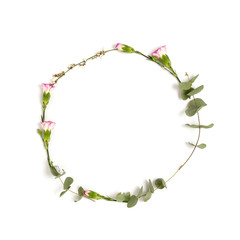 Wreath made of flowers and eucalyptus on a white background. Festive floral frame with place for text.