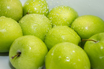 Washing fruit. Wet apples in the shower. Girl washes fruits and vegetables for the prevention of coronavirus covid-19 2019-ncov