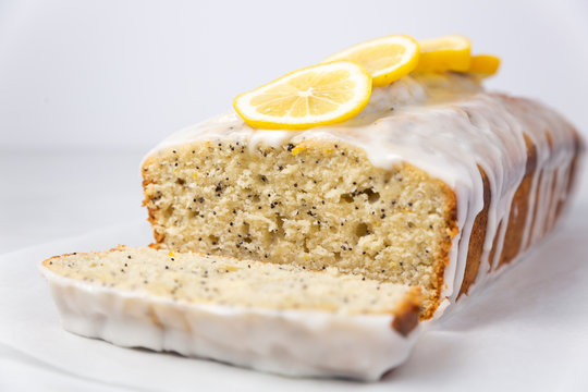 Lemon poppy seed loaf with slice cut off on white