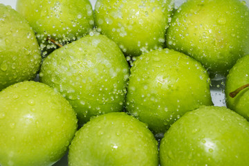 Washing fruit. Wet apples in the shower and water drops. Girl washes fruits and vegetables for the prevention of coronavirus covid-19 2019-ncov