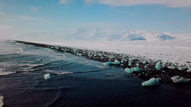 Ice with black sand beach at Jokulsarlon beach Diamond beach in Iceland. Aerial view