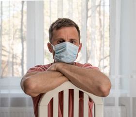 Man in protective face mask at home