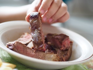Oil tallow on beef steak stick in hold woman hand saturated fatty acid