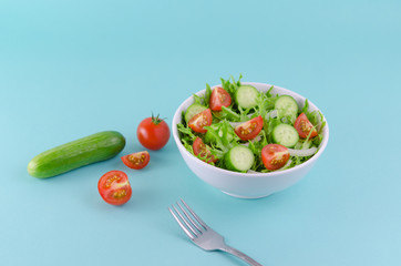 Salad bowl with frisee lettuce, baby tomato, cucumber, onion... Healthy foods concept