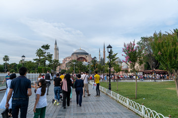 Naklejka premium Park near Hagia Sophia and a lot of locals who are walking around in the evening. July 2019