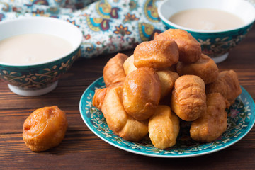 baursaki in a plate with a national pattern, Bashkir dishes, Uzbek dishes, oriental cuisine