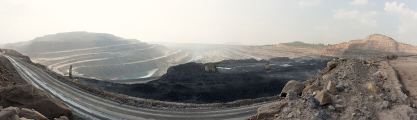 Opencast coal mine with heavy machine at work