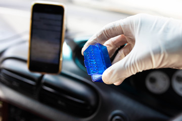 OBD2 bluetooth scanner for a car, connecting with a smartphone - diagnostics of the control unit.