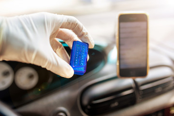 OBD2 bluetooth scanner for a car, connecting with a smartphone - diagnostics of the control unit.