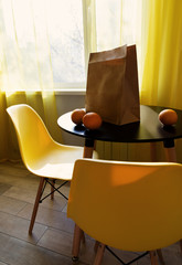 Bag with different food fruits on modern kitchen