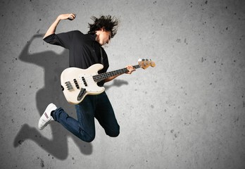 Portrait of a musician man jumps while playing